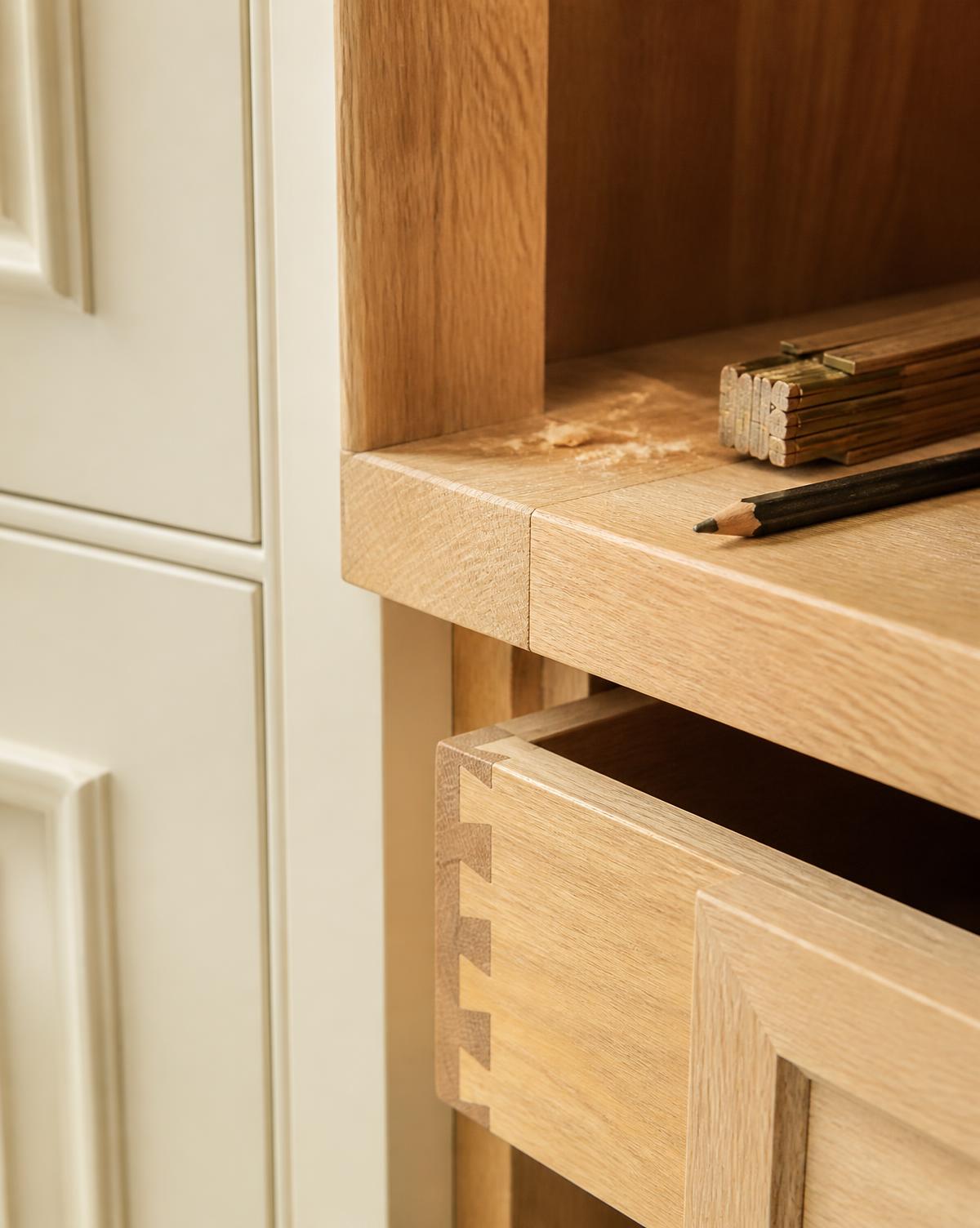 Close-up of custom oak cabinetry detail with dovetailed drawer joinery